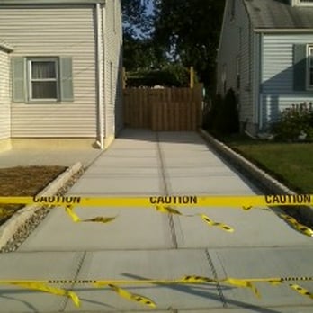 Mario Grano & Sons - length of driveway (garbage cans hidden behind privacy fence - Masonry/Concrete Near Me Mario Grano & Sons - length of driveway (garbage cans hidden behind privacy fence - Masonry/Concrete Near Me