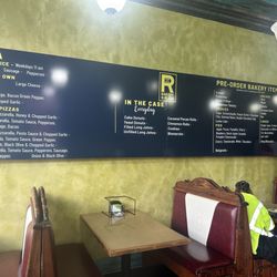 River to River Bakery & Pizza - Menu on the wall and booth seating