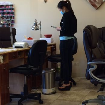 Unique Nails - Technician on her phone - Nail Salons Near Me - Broomfield, Colorado Unique Nails - Technician on her phone - Nail Salons Near Me - Broomfield, Colorado