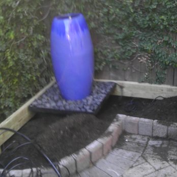 Living Trees & Shrubs - Overflowing Urn Fountain Installed in flower bed - Landscaping Near Me - Katy, Texas Living Trees & Shrubs - Overflowing Urn Fountain Installed in flower bed - Landscaping Near Me - Katy, Texas