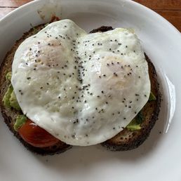 Avacado Toast, (light spinach) and over medium eggs