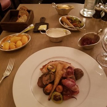 Berners Tavern - A Christmas Day feast with roasted veg, potatoes, turkey, pigs in a blanket, stuffing, and more - British Near Me - London, LND Berners Tavern - A Christmas Day feast with roasted veg, potatoes, turkey, pigs in a blanket, stuffing, and more - British Near Me - London, LND