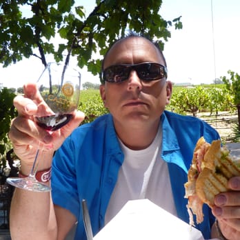 The Wine Line - Marc enjoying boxed lunch Wine Line provided, while sitting under vined trellis at Castoro Cellars - Wine Tours Near Me The Wine Line - Marc enjoying boxed lunch Wine Line provided, while sitting under vined trellis at Castoro Cellars - Wine Tours Near Me
