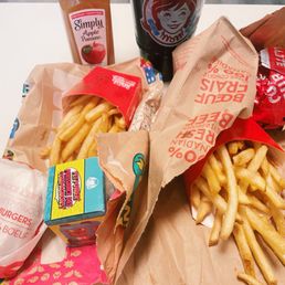 french fries, a soda and a bag of fries
