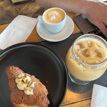 Corvus Coffee Roasters - Iced almond milk latte, cappuccino, and strawberry pistachio croissant - Coffee & Tea Near Me - Denver, Colorado