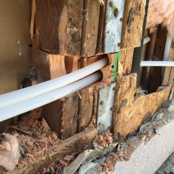 Repipe1 - Post cut ,notched. Metal strap, split by Repipe 1 in the middle, is a foundation hold-down strap embedded in concrete foundation at bottom. - Plumbing Near Me - Irvine, California Repipe1 - Post cut ,notched. Metal strap, split by Repipe 1 in the middle, is a foundation hold-down strap embedded in concrete foundation at bottom. - Plumbing Near Me - Irvine, California