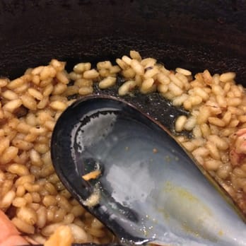 Allium - A close up of uncooked rice. Too salty and not enough flavor. - Arroceria / Paella Near Me - Barcelona, B Allium - A close up of uncooked rice. Too salty and not enough flavor. - Arroceria / Paella Near Me - Barcelona, B