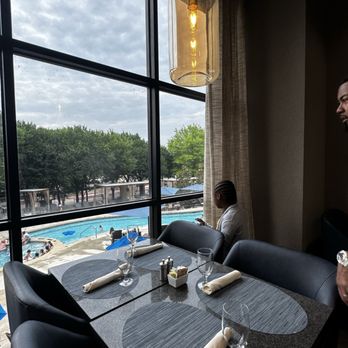 Herd & Hearth - Seating overlooking the pool - American Near Me - Frisco, Texas Herd & Hearth - Seating overlooking the pool - American Near Me - Frisco, Texas