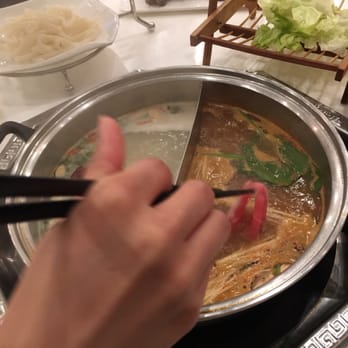IPOT - Left side: Chinese herbal (no nuts) Right side: Spicy Miso  Best combo.  Hand not included - Hot Pot Near Me - San Francisco, California