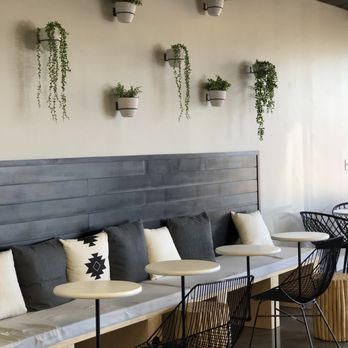 OMTea Boba & Bites - a row of tables and chairs in a restaurant - Bubble Tea Near Me - Raleigh, North Carolina OMTea Boba & Bites - a row of tables and chairs in a restaurant - Bubble Tea Near Me - Raleigh, North Carolina