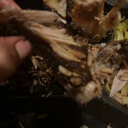 a person taking a piece of food out of a container
