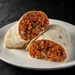 Fuego Cravings - California Burrito has hearty beans, fluffy rice, crispy fries, cheese, onions/cilantro, sour cream, al pastor and asada.