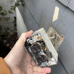 HomeLight Boston - Burned out GFCI receptacle box before repair .