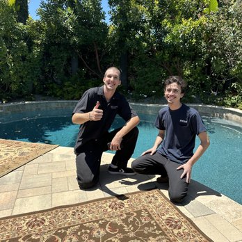Merit Carpet & Upholstery Cleaning - Micah and Ryan laying out the rugs to dry in the backyard, excellent team work! - Carpet Cleaning Near Me Merit Carpet & Upholstery Cleaning - Micah and Ryan laying out the rugs to dry in the backyard, excellent team work! - Carpet Cleaning Near Me