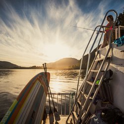 Take Off Adventure Rentals - Stand Up Paddle Board on the back of the house boat on Lake Cowichan