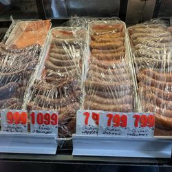 European Deluxe Sausage Kitchen - Here are photos of what's in the cases, which is more accurate than the old metal signs on the wall.