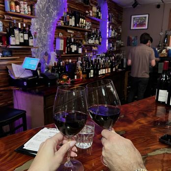 Swirlery - two people clinking wine glasses - Wine Bars Near Me - Orlando, Florida
