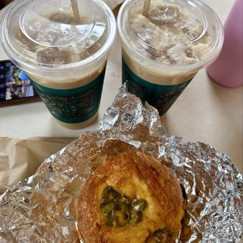 Cajé Coffee Roasters - Haley St - Jalapeño cheddar bagel with cream cheese with iced caramel latte, deliciousness in one picture - Coffee Roasteries Near Me - Santa Barbara, California