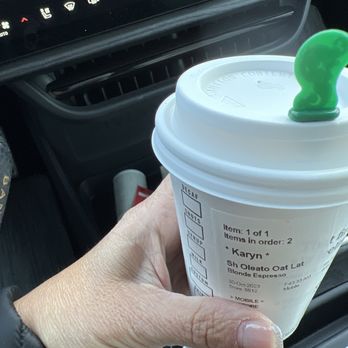 Starbucks - a hand holding a cup of coffee - Coffee & Tea Near Me - Highwood, Illinois