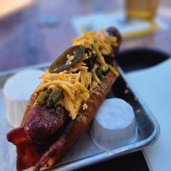 The Welcome Back Lounge - Brats bacon jalapeño cheese dog. DELISH