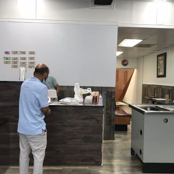 Spice 21 - a man standing at a counter in a restaurant - Indian Near Me - Warren, Michigan