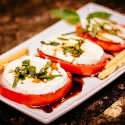Bella Vino Wine & Cheese Market - Imported Buffalo Mozzarella is used on organic tomatoes with reduced balsalmic and fresh basil grown on site
