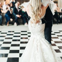 Elevate the romance of your wedding dance by adding a graceful dip and a tender kiss.