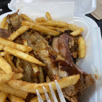 TNT BBQ & Grill - a plate of french fries and meat - Barbeque Near Me - Melbourne, Florida