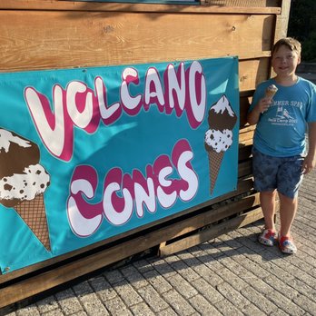 Volcano Cones - Sign and son with his single split cone - Desserts Near Me - Government Camp, Oregon