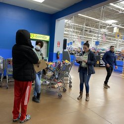 Walmart Supercenter - Three members of staff reshopping my cart.
