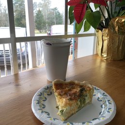 a slice of quiche and a cup of coffee