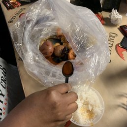 a person holding a spoon over a bowl of food