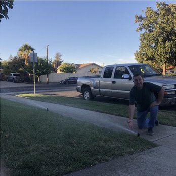 Premium Landscape - a man standing on a sidewalk in front of a pickup truck - Landscaping Near Me Premium Landscape - a man standing on a sidewalk in front of a pickup truck - Landscaping Near Me