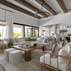 Maya Axt Interiors - Large open concept living room with wood beams, light furniture.