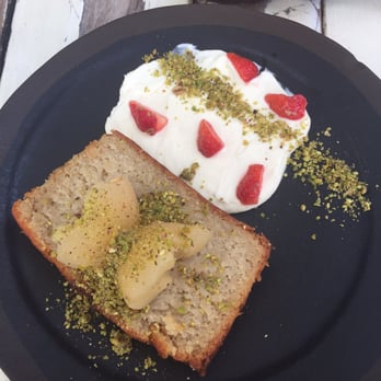 Brunch & Cake - Coconut cake with cream cheese frosting on the side and a delicious pear on top - Breakfast & Brunch Near Me - Barcelona, B