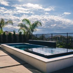 Thomas Pools - Elevated infinity spa with Baja and stacked stone water feature