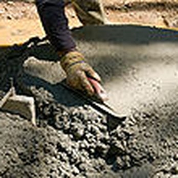 Dog Construction - a man pouring concrete into a bowl - General Contractors Near Me - Seattle, Washington