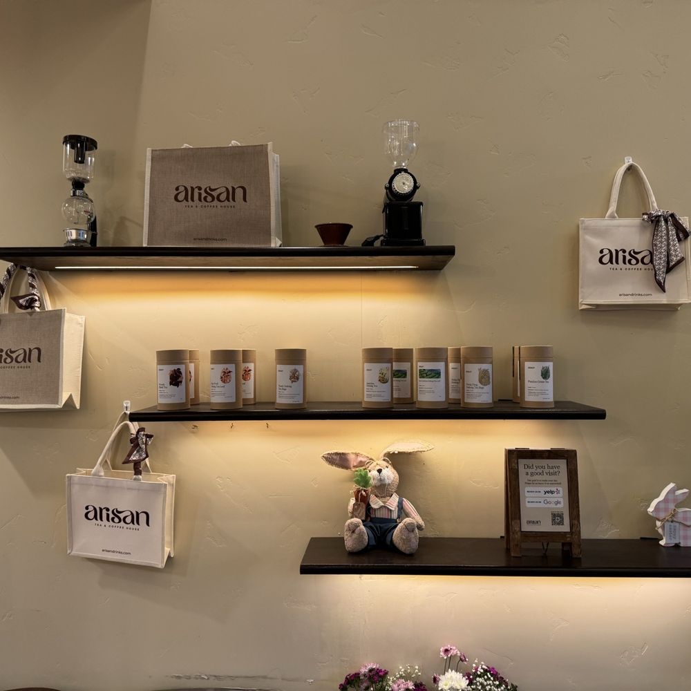 Arisan Tea & Coffee House - Wall shelves with branded totes + to go canisters of loose leaf tea - Coffee & Tea Near Me - San Jose, California