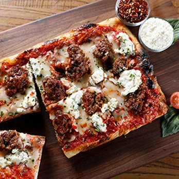 P.Za Kitchen - a pizza on a cutting board - Food Delivery Services Near Me P.Za Kitchen - a pizza on a cutting board - Food Delivery Services Near Me