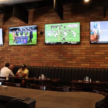 T-Bird Tavern - a group of people sitting at a table watching televisions - Cocktail Bars Near Me - Scottsdale, Arizona T-Bird Tavern - a group of people sitting at a table watching televisions - Cocktail Bars Near Me - Scottsdale, Arizona