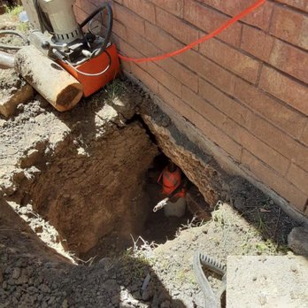 Leones Foundation Repair - pushing the piers - Foundation Repair Near Me