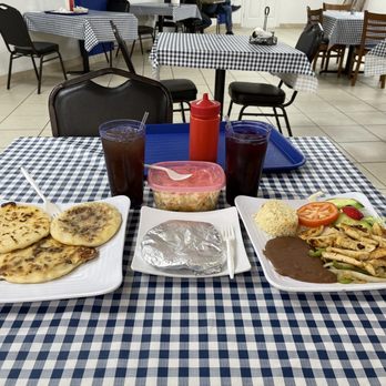 Pupuseria Emanuel - two plates of food on a table - Salvadoran Near Me - Houston, Texas Pupuseria Emanuel - two plates of food on a table - Salvadoran Near Me - Houston, Texas
