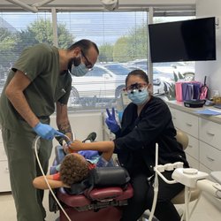 Team work at it's best. Wendy (hygienist) & Jose  (dental assistant) with our wonderful patient.