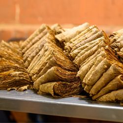 J.C. Newman Cigar Company - Piles of tobacco ready for the next step