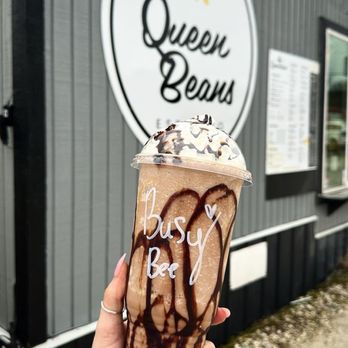 Queen Beans Espresso - a hand holding a cup of coffee - Coffee & Tea Near Me - Fort Smith, Arkansas