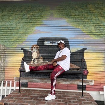 Bolton Hometown Tour - Our driver demonstrates a good pose at the photo opp near Southern Sisters shop. - Historical Tours Near Me - Laurel, Mississippi