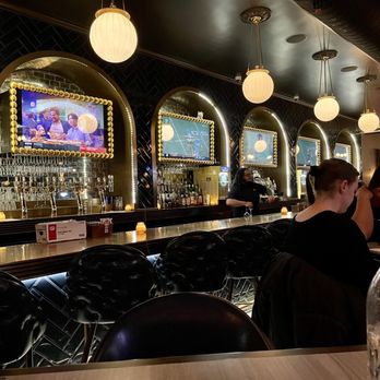The Whale Chicago - a man sitting at a bar - New American Near Me - Chicago, Illinois