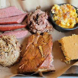 Baby back ribs and a three meat combo with pulled pork, moist brisket, classic sausage, mac and cheese, and cornbread