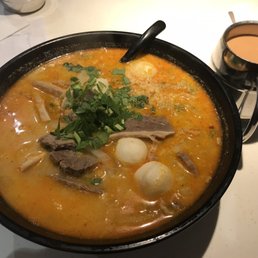 Beef brisket, fish balls, and instant noodles in laksa broth Beef brisket, fish balls, and instant noodles in laksa broth