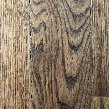 Affordable Flooring & Remodeling - Large gaps between boards, attempted to fill in with mis-colored wood putty - Flooring Near Me - Aurora, Colorado